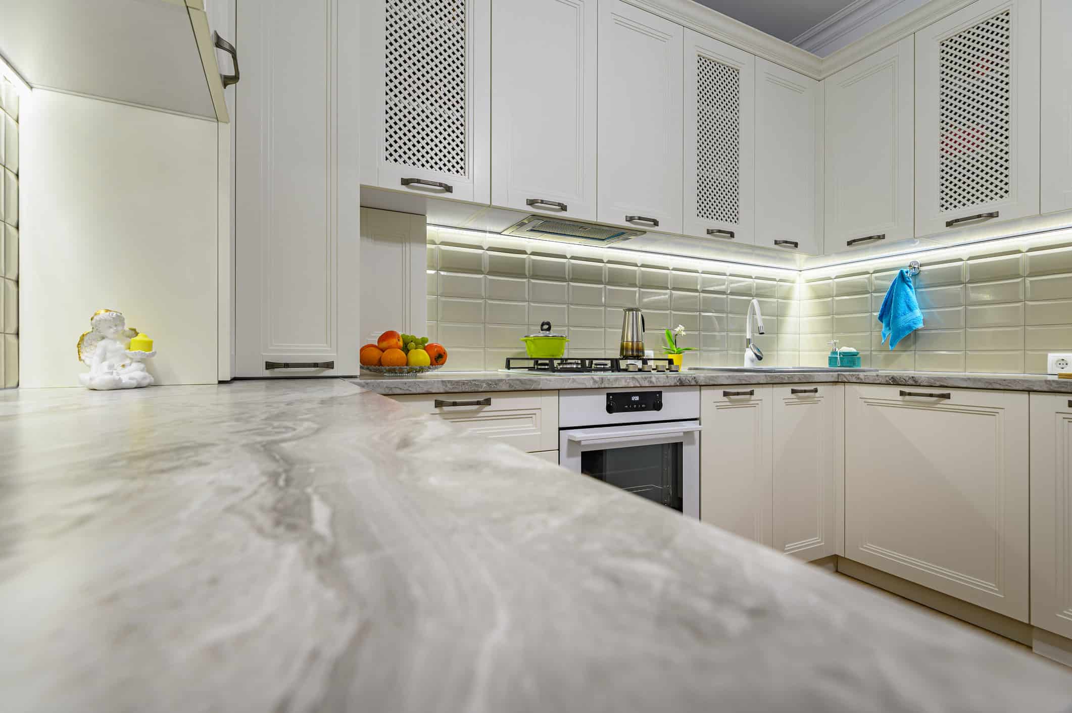 Interior Painting – White Kitchen Cabinets & Marble Countertop White kitchen with marble countertop and under-cabinet LED lighting — interior painting by licensed house painters MA