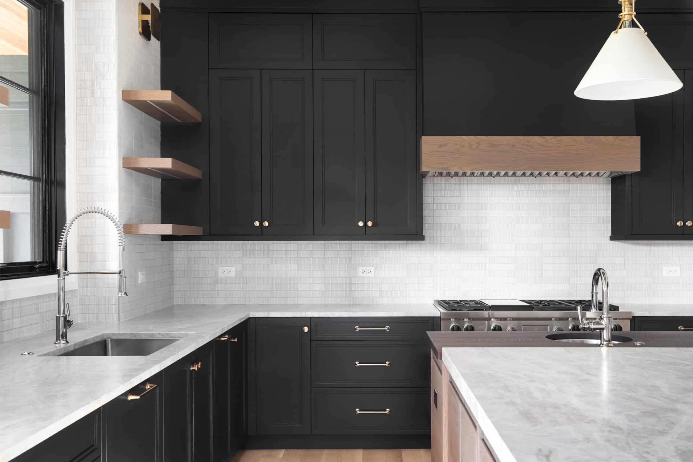 Cabinet Painting – Black Shaker Kitchen Makeover | Painting Contractor in Middlesex County MA Modern kitchen with matte black cabinets, marble countertops, and brass hardware — cabinet painting Middlesex County MA