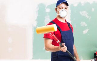 Portrait Of A Masked Painter At Work In An Apartment