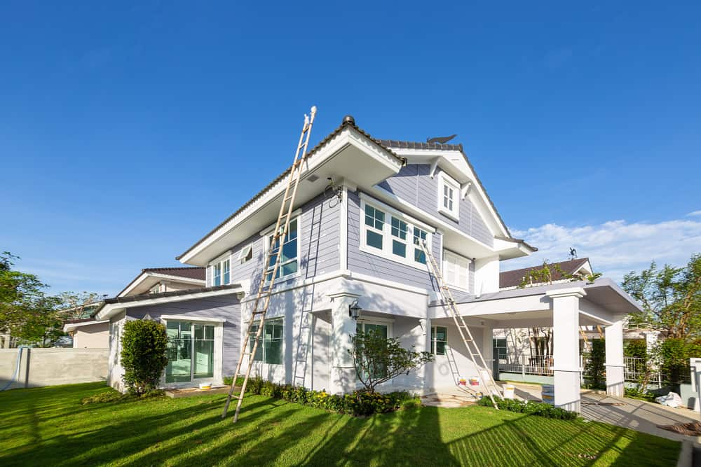 Exterior View Of New House Under Construction And Painting