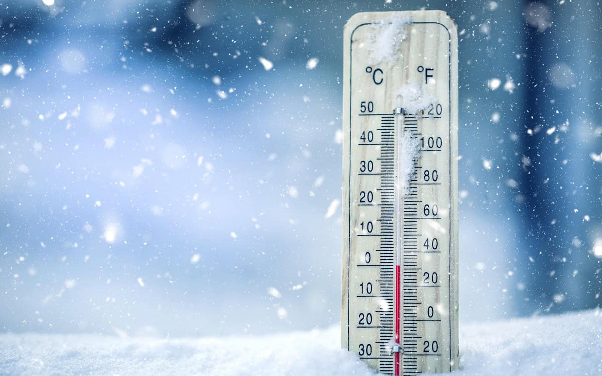 Thermometer on snow shows low temperatures – zero. Low temperatures in degrees Celsius and fahrenheit. Cold winter weather – zero celsius thirty two farenheit