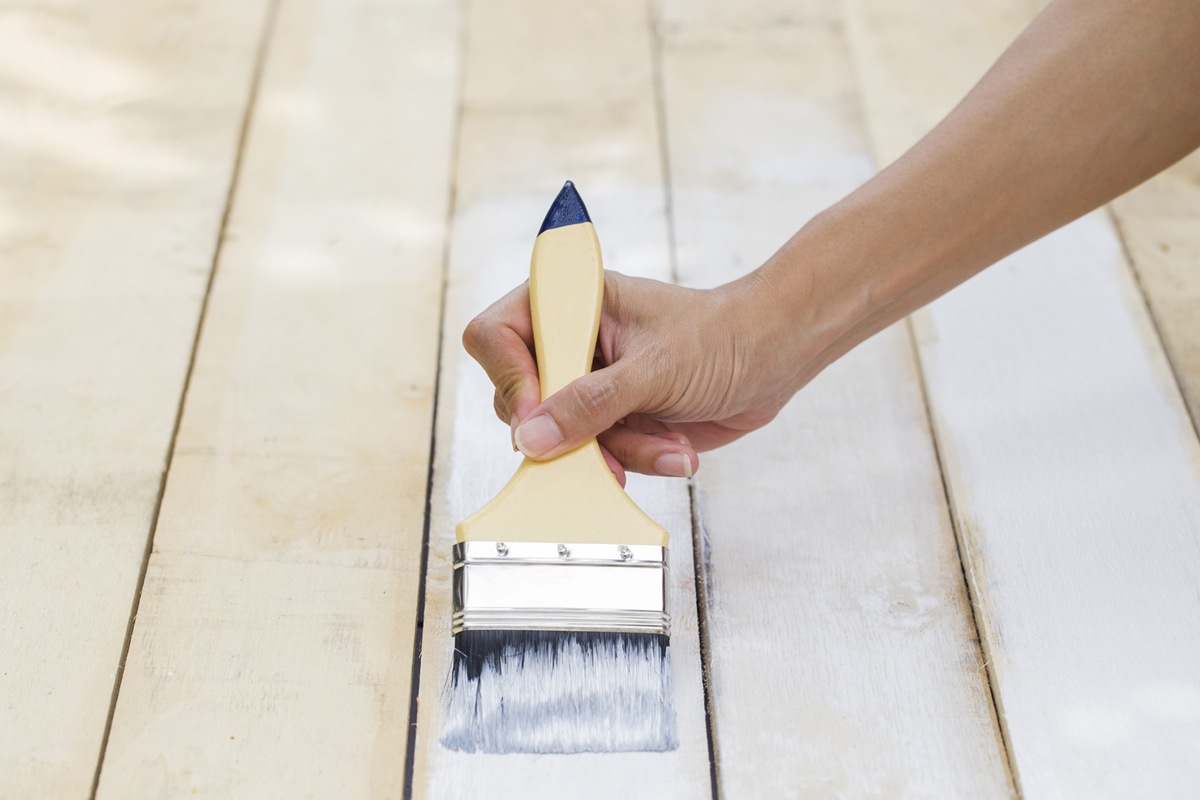 Applying protective varnish on a wooden furniture